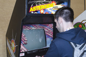 Man plays classic arcade cabinet Asteroids